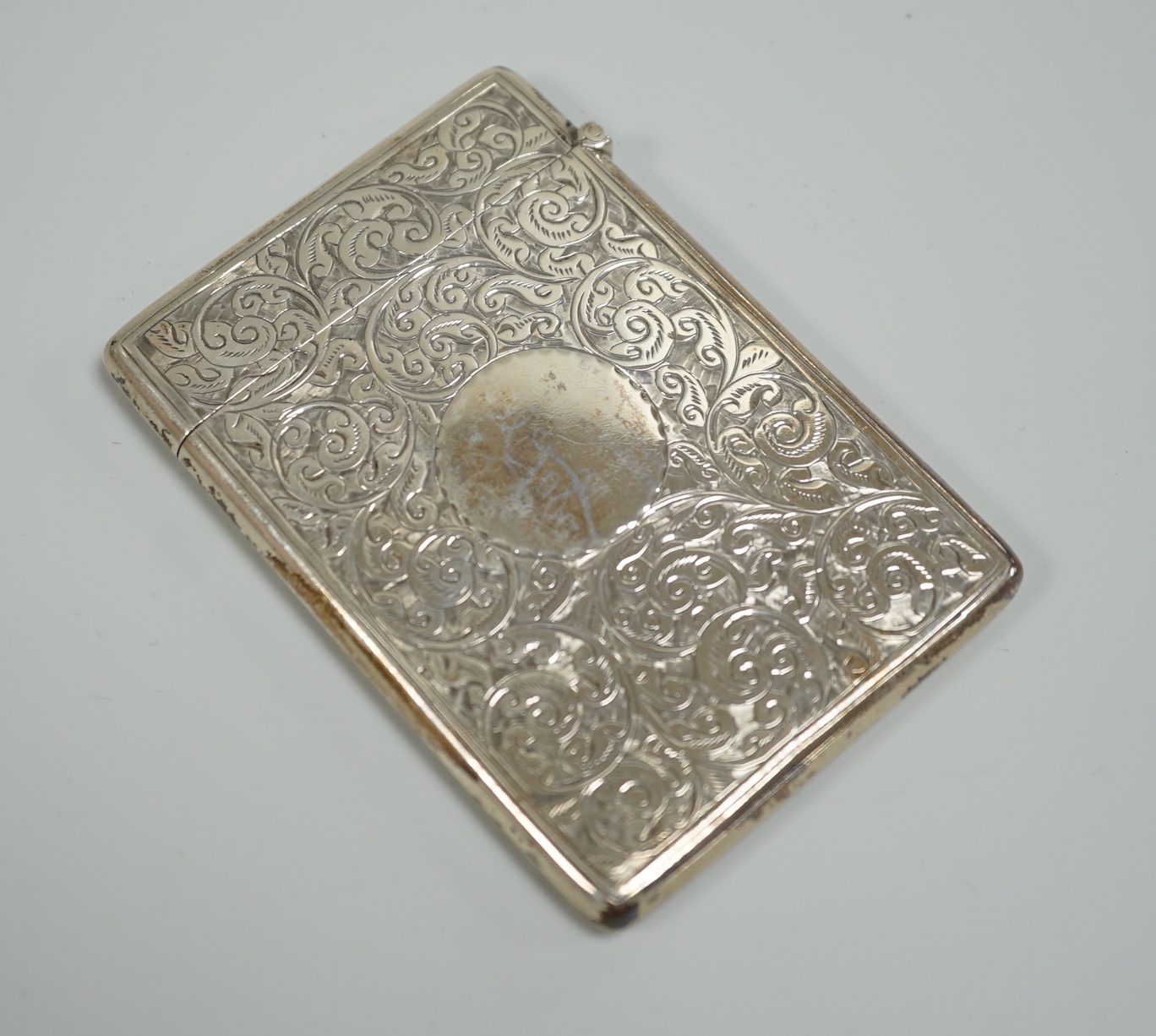 An Edwardian chased silver rectangular card case, Deakin & Francis, Birmingham, 1903, 95mm, in fitted leather case.